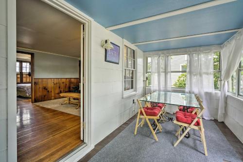 a home office with a glass table and chairs at Point Pleasant Abode with Lagoon and Boat Dock! in Point Pleasant