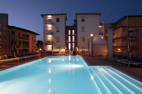 a large swimming pool in front of a building at Hotel Bristol in Caorle