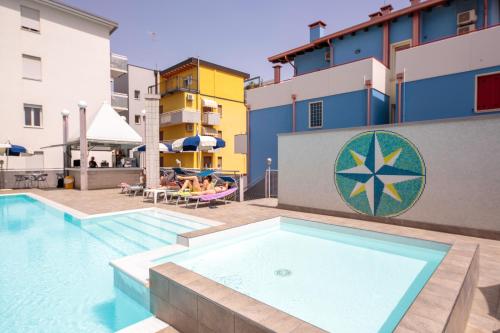 a pool at a hotel with people sitting on a raft at Hotel Bristol in Caorle