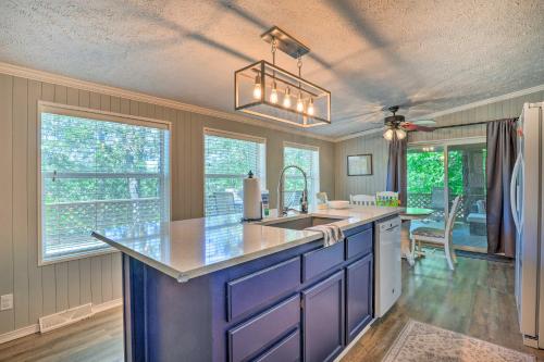 a kitchen with a sink and a counter top at Noteworthy Cabin Grill, Walk to Beaver Lake! in Rogers