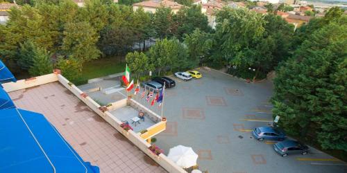 an overhead view of a parking lot with cars and flags at Valdenza Hotel in Campegine