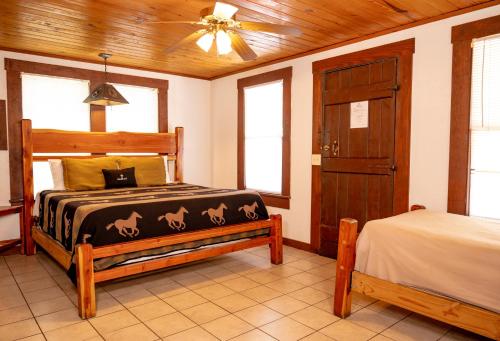 a bedroom with a bed and a ceiling fan at THE VAQUERO MOTEL in Bandera
