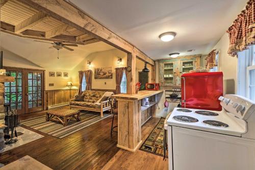 a kitchen with a stove and a red refrigerator at Trails and Creek On-Site Tranquil Greentown Cabin in Greentown