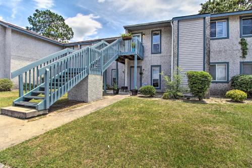 a house with a blue staircase in the yard at Hinesville Condo Grill, 4 Mi to Fort Stewart in Hinesville