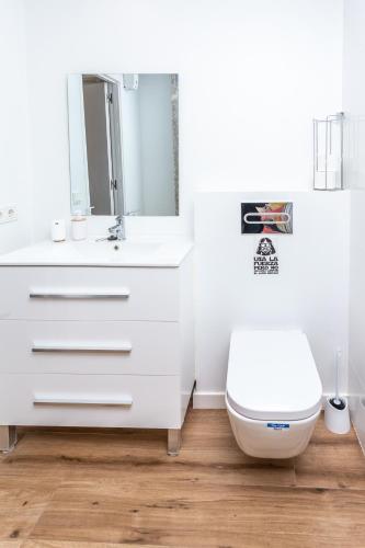 a bathroom with a white sink and a toilet at We Hostel Palma - Albergue Turístico in Palma de Mallorca
