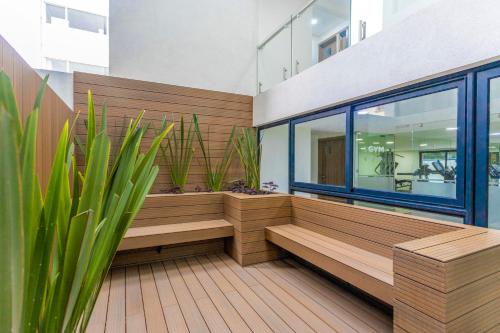 a room with benches and plants in a building at Del Valle Luxury Apartment in Mexico City