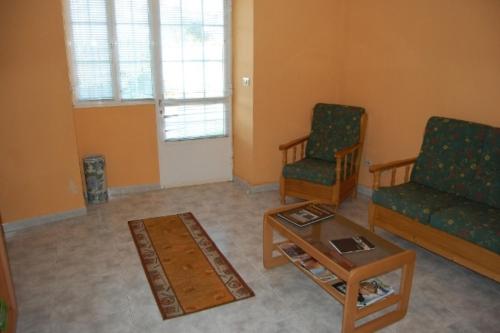 a living room with two chairs and a coffee table at Casa Farruquitas in Cervo