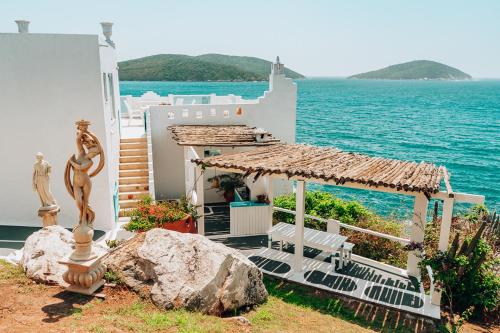 a house with a view of the ocean at Casa Grega in Arraial do Cabo