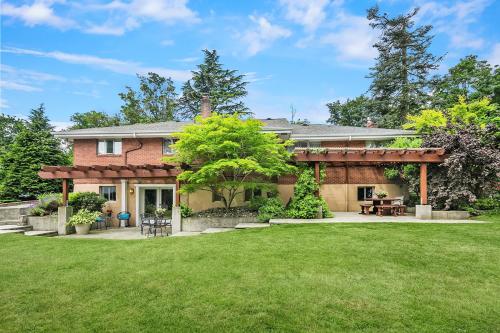 a brick house with a pergola in a yard at Ravenna Retreat - Free Parking - 1GBPS Fiber WIFI - Near UW in Seattle