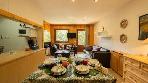 a living room with a table with plates on it at Apartamentos Formigal - Admite mascotas in Formigal