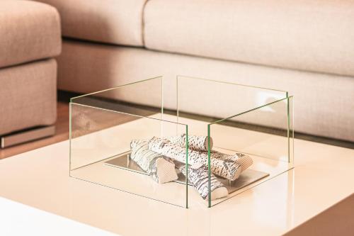 a glass cube on a coffee table in front of a couch at Stunning view lakeside apartment - Larihome A11 in Gravedona