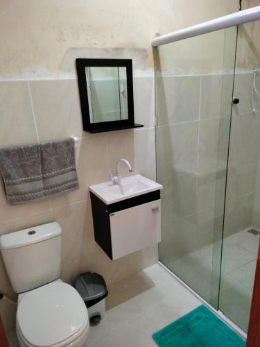 a bathroom with a toilet and a sink and a shower at CASA COM PISCINA sensacional in Barreirinhas