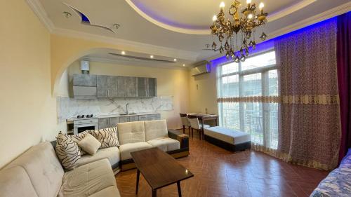 a living room with a couch and a table at Green House in K'obulet'i