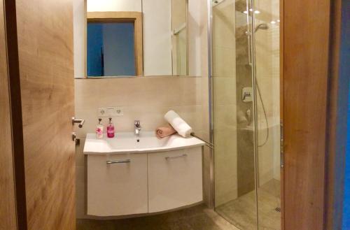 a bathroom with a sink and a shower at Ferienwohnung Leo in Stummerberg