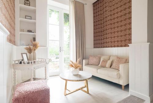 a living room with a couch and a table at Villa Bokeh Relais & Châteaux in Antigua Guatemala