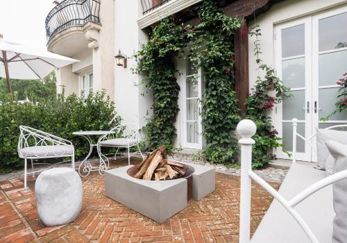 a patio with a fire pit in front of a house at Villa Bokeh Relais & Châteaux in Antigua Guatemala