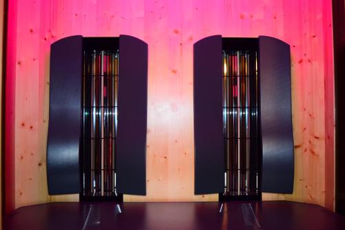 two black chairs in front of a pink wall at Hotel Garni Maria Theresia in Sölden
