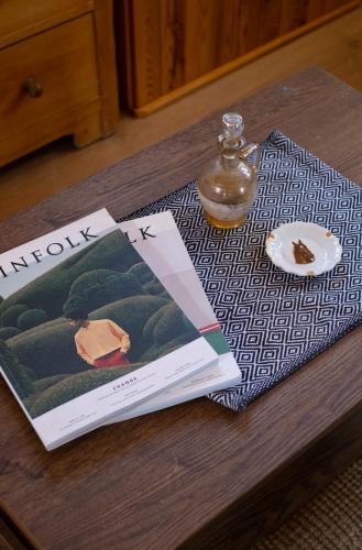 a table with a book and a plate of food at Kuca pod Rudnikom in Trudelj