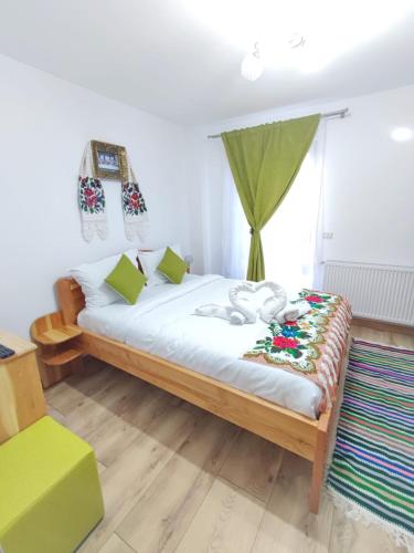 a bedroom with a bed with a stuffed animal on it at Vila CASA HATERE in Moisei