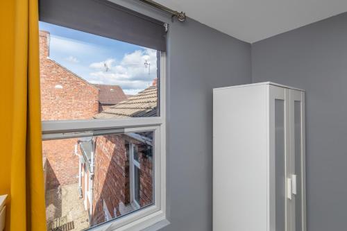 a window with a view of a brick building at Middlesbrough Town Centre Double Private Rooms in Middlesbrough