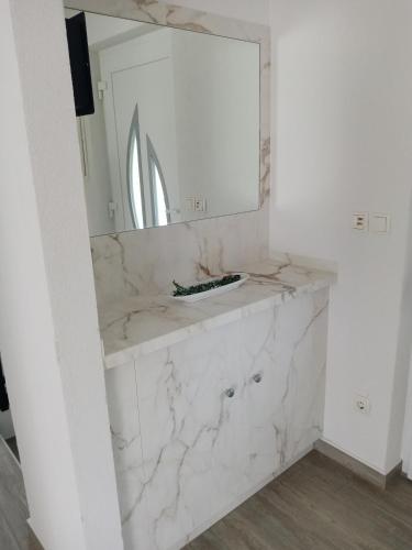 a bathroom with a white marble counter and a mirror at Villa Marie 5-Sterne in Kornić