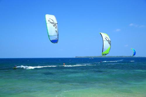a group of people kite surfing in the ocean at Trikora Beach Club and Resort in Telukbakau