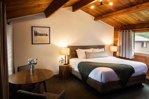 a bedroom with a bed and a wooden ceiling at Miette Mountain Cabins in Jasper