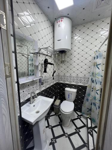 a bathroom with a sink and a toilet at Bruce hostel in Dushanbe