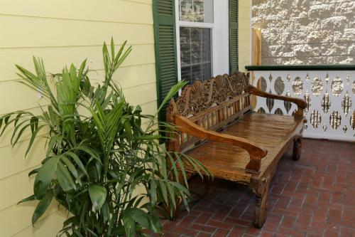 a wooden bench sitting on the porch of a house at Inn on the Avenue in New Smyrna Beach