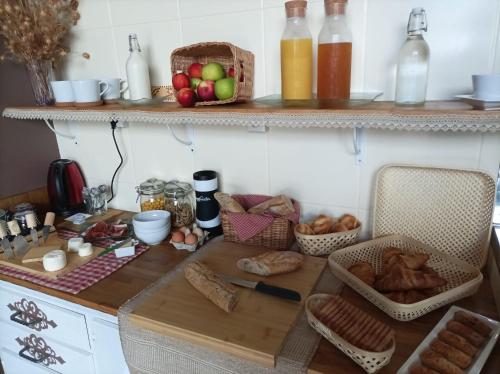 a kitchen with a table with bread and fruit on it at Cadol'Ain in Servignat