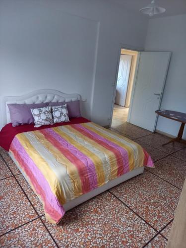 een slaapkamer met een bed met een kleurrijk dekbed bij Serravalle Apartment in Serravalle Scrivia