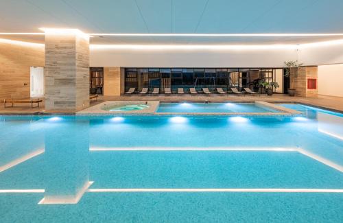 a swimming pool in a hotel with blue water at Nido at Neuchatel Polanco in Mexico City