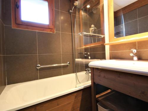 une salle de bain avec une baignoire et un lavabo dans l'établissement Bel appartement rénové · Balcon · Proche pistes et commerces · Casier à ski - FR-1-181-2460, à La Plagne Tarentaise