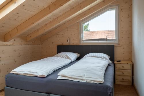 a bedroom with two beds in a tiny house at Alb Chalet in Meßstetten