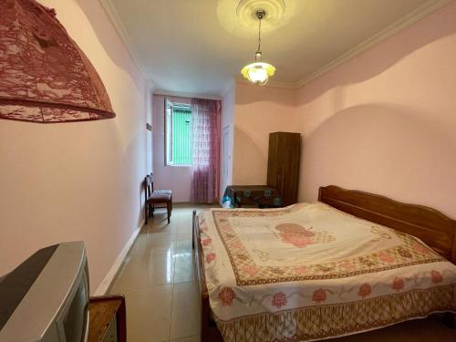 a bedroom with a bed in a room at Green House in K'obulet'i