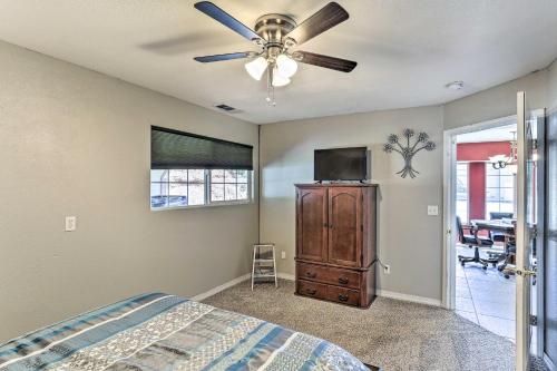 a bedroom with a ceiling fan and a tv at Private Pool and Game Room Family Weaverville Gem in Weaverville