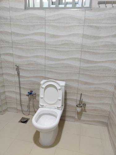 a bathroom with a toilet and a shower at FAD Home & Apartments in Dodoma