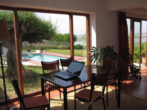 a laptop on a table in a room with a pool at Villa Zahra in Larache