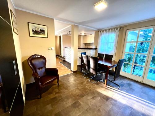 a living room with a dining room table and chairs at Central Park Residence in Belgrade