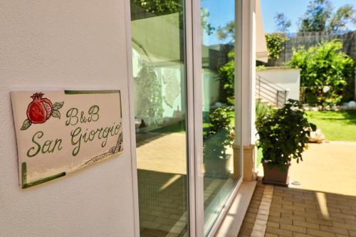 a sign on the door of a house at B&B SANGIORGIO Green living in Melpignano