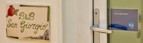 a sign on the door of a refrigerator at B&B SANGIORGIO Green living in Melpignano