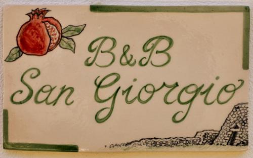 a cake with a sign that reads bid san circumpoca at B&B SANGIORGIO Green living in Melpignano