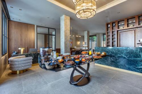 a lobby with a buffet of food on a table at ASKLIPIOS LUXURY ROOMS in Nafpaktos