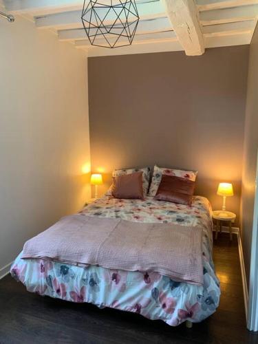 a bedroom with a bed with two pillows on it at Gîte Mac Arthur in Bulson