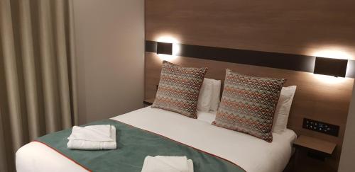 Ένα ή περισσότερα κρεβάτια σε δωμάτιο στο Merit Kensington Hotel