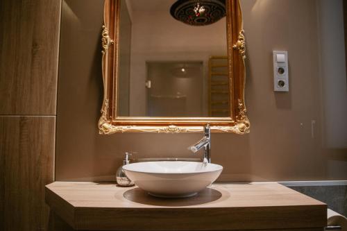 a bathroom with a bowl sink and a mirror at Luxury Flat Near Castle Hill in Budapest