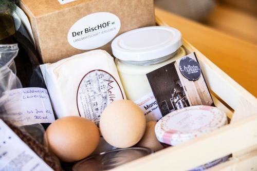 a box filled with eggs and a bottle of butter at Wasserfall Apartments Mellau in Mellau