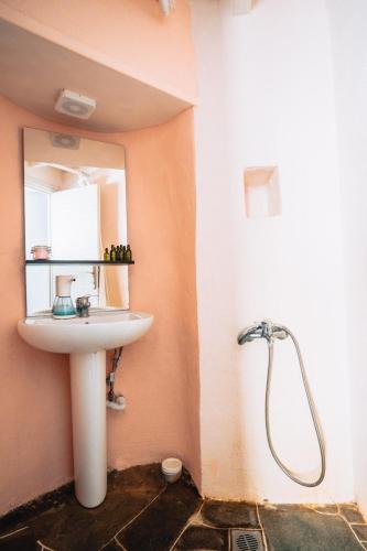 a bathroom with a sink and a mirror at Avra Guestroom in Apollonia