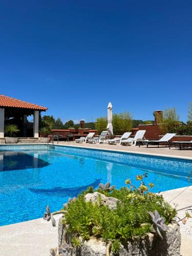 a swimming pool with lounge chairs next to a resort at Gorana apartman with swimming pool in Jelsa