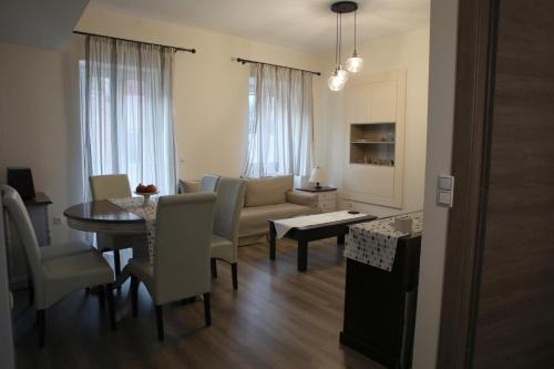 a living room with a table and a couch and a dining room at Casa Domenica in Corfu Town